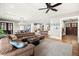 Open-concept living room with hardwood floors, large sectional, and seamless flow to kitchen at 2118 Lake Dr, Winter Park, FL 32789