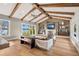 Spacious living room with wood beam ceilings, hardwood floors, fireplace, and a scenic lake view at 2118 Lake Dr, Winter Park, FL 32789