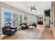 A bright and airy living room with lake views, modern furniture, and a unique spiral staircase at 2118 Lake Dr, Winter Park, FL 32789