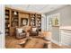 Home office features custom built-in shelving, hardwood floors, and a door leading to a private balcony at 2118 Lake Dr, Winter Park, FL 32789