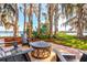 Outdoor patio featuring comfortable seating and picturesque waterfront views surrounded by mature trees at 2118 Lake Dr, Winter Park, FL 32789