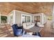 Wide, covered porch featuring wood ceiling, seating, and scenic views of the water at 2118 Lake Dr, Winter Park, FL 32789