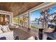 Relax on this spacious porch with a wood ceiling and railing overlooking water views at 2118 Lake Dr, Winter Park, FL 32789