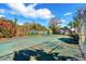 Outdoor tennis court surrounded by lush landscaping, mature trees and natural beauty at 2118 Lake Dr, Winter Park, FL 32789