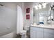 Clean bathroom featuring a shower-tub combo, vanity, and ample lighting at 2304 Silver Palm Dr # 103, Kissimmee, FL 34747