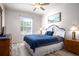 Comfortable bedroom with a queen-sized bed, ceiling fan, and wood-look flooring at 2304 Silver Palm Dr # 103, Kissimmee, FL 34747