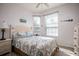 Cozy bedroom with two windows and comfortable bed with floral patterned bedding at 2304 Silver Palm Dr # 103, Kissimmee, FL 34747