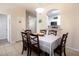 A dining room with a table set for six next to a pass-through window to the kitchen at 2304 Silver Palm Dr # 103, Kissimmee, FL 34747