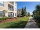 Manicured apartment complex with lush green landscaping, mature trees, and inviting walkway at 2304 Silver Palm Dr # 103, Kissimmee, FL 34747