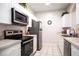 Functional kitchen featuring stainless steel appliances, white cabinetry, and sleek countertops at 2304 Silver Palm Dr # 103, Kissimmee, FL 34747