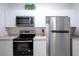 Modern kitchen showcasing stainless steel appliances, sleek countertops, and bright white cabinets at 2304 Silver Palm Dr # 103, Kissimmee, FL 34747