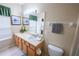 Bright bathroom featuring a large mirror, vanity, and toilet at 2412 Caravelle Cir, Kissimmee, FL 34746