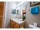 Bathroom featuring a single sink vanity, white toilet, and framed mirror with decorative elements at 2412 Caravelle Cir, Kissimmee, FL 34746