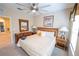 Bright Bedroom with a large bed, ceiling fan, bedside tables, and two windows at 2412 Caravelle Cir, Kissimmee, FL 34746