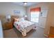 Cozy bedroom features a comfortable bed with floral patterns and a ceiling fan at 2412 Caravelle Cir, Kissimmee, FL 34746