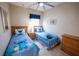 Charming bedroom with two twin beds, themed bedding, and a ceiling fan at 2412 Caravelle Cir, Kissimmee, FL 34746