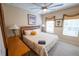 Bright Bedroom includes a large bed, ceiling fan, two windows, and two bedside tables at 2412 Caravelle Cir, Kissimmee, FL 34746