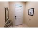 Bright entryway with tiled floors and a decorative mirror, creating an inviting and stylish welcome at 2412 Caravelle Cir, Kissimmee, FL 34746