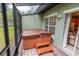 Screened-in patio with a hot tub and an outdoor seating area at 2412 Caravelle Cir, Kissimmee, FL 34746