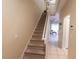Carpeted staircase leading to the upper level, providing access to the home's living spaces at 2412 Caravelle Cir, Kissimmee, FL 34746