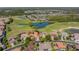 Stunning aerial view of home near golf course, water features, and other houses in well maintained community at 2442 Heritage Green Ave, Davenport, FL 33837