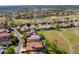 Beautiful aerial view of neighborhood with houses backing onto golf course with trees and water features at 2442 Heritage Green Ave, Davenport, FL 33837