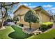 Beautiful backyard, manicured lawn, mature trees, and stone landscaping at 2442 Heritage Green Ave, Davenport, FL 33837
