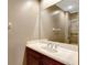 Bathroom vanity with solid surface counter, mirror, and updated plumbing fixtures at 2442 Heritage Green Ave, Davenport, FL 33837