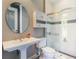 Bright bathroom featuring a pedestal sink, stylish fixtures, and a glass-enclosed shower at 2442 Heritage Green Ave, Davenport, FL 33837