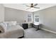 Bedroom with a ceiling fan, two windows, a comfortable bed, and a desk illuminated by natural light at 2442 Heritage Green Ave, Davenport, FL 33837