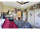 Cozy bedroom with a ceiling fan, colorful bedding, a plush penguin, and access to the en-suite bathroom at 2442 Heritage Green Ave, Davenport, FL 33837