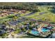 Aerial shot showcasing a community featuring homes, a golf course, lakes, and a clubhouse at 2442 Heritage Green Ave, Davenport, FL 33837