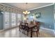 Charming dining area with ample natural light from the glass doors and neutral decor at 2442 Heritage Green Ave, Davenport, FL 33837