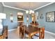 Stylish dining room with elegant decor, chandelier, and open access to other living areas at 2442 Heritage Green Ave, Davenport, FL 33837