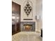 Close-up view of the fireplace with a decorative mantle, built-in shelving, and a modern floor lamp at 2442 Heritage Green Ave, Davenport, FL 33837