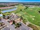 Beautiful aerial view of a meticulously maintained golf course and country club with lush greenery and serene ponds at 2442 Heritage Green Ave, Davenport, FL 33837