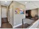 Hallway with hardwood floors, an artwork, and a wrought iron railing leading to an open office space at 2442 Heritage Green Ave, Davenport, FL 33837