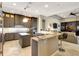 Open-concept kitchen with granite countertops, stainless steel appliances, and breakfast bar seating at 2442 Heritage Green Ave, Davenport, FL 33837