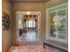 Elegant entryway leading to a bright living room with stylish decor and large windows at 2442 Heritage Green Ave, Davenport, FL 33837