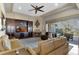Inviting living room featuring a fireplace, built-in shelving, and sliding glass doors to the outdoor area at 2442 Heritage Green Ave, Davenport, FL 33837
