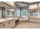 Bright bathroom features double sinks, soaking tub, and neutral tile at 2442 Heritage Green Ave, Davenport, FL 33837