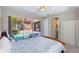 Relaxing bedroom with a sliding glass door that leads to the pool and lanai area at 2442 Heritage Green Ave, Davenport, FL 33837