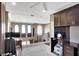 Upstairs office with a built-in desk, neutral carpet, ceiling fan, and an opening with wrought iron rails at 2442 Heritage Green Ave, Davenport, FL 33837