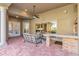 Covered outdoor living space with brick patio, fan, and outdoor kitchen at 2442 Heritage Green Ave, Davenport, FL 33837