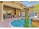 Outdoor living area with private pool, spa, built-in grill, and ample seating at 2442 Heritage Green Ave, Davenport, FL 33837