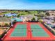 Aerial shot of tennis courts and community amenities, including pools, golf course, and a clubhouse at 2442 Heritage Green Ave, Davenport, FL 33837
