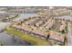 Community of townhomes around a lake, lush landscaping, and many amenities at 3185 Pequod Pl, Kissimmee, FL 34746