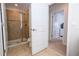 Bathroom with tiled shower featuring a sliding glass door and neutral color palette at 3185 Pequod Pl, Kissimmee, FL 34746