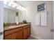 Bathroom featuring a double sink, granite countertops, decorative tile, mirror, and updated fixtures at 3185 Pequod Pl, Kissimmee, FL 34746