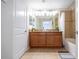 Bathroom with double sinks, granite counters, tiled floors, and tub with shower at 3185 Pequod Pl, Kissimmee, FL 34746